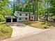 Charming home with a two-car garage, long driveway, and beautiful yard surrounded by mature trees at 4058 Daron Ct, Ellenwood, GA 30294