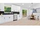 Modern kitchen featuring white cabinets, stainless steel appliances, and an adjacent dining area at 4058 Daron Ct, Ellenwood, GA 30294