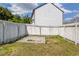 Backyard featuring a white fence, grassy area and brick fire pit area at 1043 Lexus Dr, Lawrenceville, GA 30045