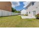 Spacious backyard featuring a white fence, green grass, patio and outdoor trampoline at 1043 Lexus Dr, Lawrenceville, GA 30045