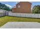 Fenced backyard with established lawn and concrete patio, ideal for outdoor living at 1043 Lexus Dr, Lawrenceville, GA 30045