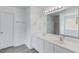 Bright bathroom with double sinks, white cabinets, a large mirror, and a separate tub and shower at 1043 Lexus Dr, Lawrenceville, GA 30045