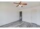 A bright bedroom with gray wood flooring showing access to the stairs at 1043 Lexus Dr, Lawrenceville, GA 30045