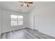Bedroom with grey wood flooring and a window for natural light at 1043 Lexus Dr, Lawrenceville, GA 30045