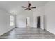Large bedroom with light gray wood-look floors, white walls, a ceiling fan, and multiple doorways at 1043 Lexus Dr, Lawrenceville, GA 30045