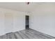 Bedroom with gray wood flooring showing access to the stairs at 1043 Lexus Dr, Lawrenceville, GA 30045