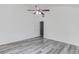 Bright bedroom with neutral walls, ceiling fan and modern gray-tone laminate flooring at 1043 Lexus Dr, Lawrenceville, GA 30045