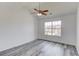 A bright bedroom with gray wood flooring and a ceiling fan at 1043 Lexus Dr, Lawrenceville, GA 30045