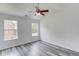 Bedroom with gray wood floors and natural light from two windows at 1043 Lexus Dr, Lawrenceville, GA 30045