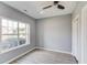 This bedroom has grey walls, wood-look flooring, and a large window letting in plenty of natural light at 1043 Lexus Dr, Lawrenceville, GA 30045