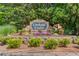 Stone entrance to Creekside Estates community with colorful flowers and landscaping at 1043 Lexus Dr, Lawrenceville, GA 30045
