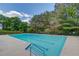 Community pool with trees and landscaping around it at 1043 Lexus Dr, Lawrenceville, GA 30045