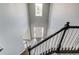 Two-story foyer featuring wood-look flooring and gray walls as seen from the top of the stairs at 1043 Lexus Dr, Lawrenceville, GA 30045