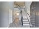 Open foyer with staircase, neutral paint, and plank flooring that leads to the kitchen at 1043 Lexus Dr, Lawrenceville, GA 30045