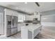 Updated kitchen with stainless appliances, white cabinets, and marble island at 1043 Lexus Dr, Lawrenceville, GA 30045