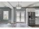 Open kitchen and dining area with stainless steel appliances, white cabinets, and views to the backyard at 1043 Lexus Dr, Lawrenceville, GA 30045