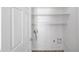 Laundry room with white walls, wood-look floors, open shelving, and washer/dryer hookups at 1043 Lexus Dr, Lawrenceville, GA 30045