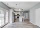 This living room view showcases the open floor plan with the kitchen and dining area in view at 1043 Lexus Dr, Lawrenceville, GA 30045