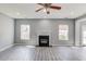 Bright living room featuring a fireplace, updated paint, and large windows offering plenty of natural light at 1043 Lexus Dr, Lawrenceville, GA 30045
