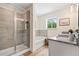Modern bathroom with a separate glass-enclosed shower and soaking tub, dual sinks, and wood-look flooring at 201 Starr Cir, Stockbridge, GA 30281