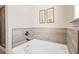 Clean, soaking tub featuring tiled walls and sleek fixtures, creating a perfect spa-like experience at 201 Starr Cir, Stockbridge, GA 30281