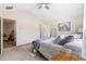 Carpeted bedroom featuring neutral decor, ceiling fan, and a view into an adjacent room at 201 Starr Cir, Stockbridge, GA 30281