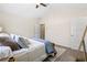 Carpeted bedroom featuring neutral decor, ceiling fan, and ensuite bathroom at 201 Starr Cir, Stockbridge, GA 30281