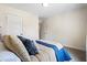 Bright bedroom features a large bed, neutral walls, and an adjoining door at 201 Starr Cir, Stockbridge, GA 30281