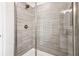 Contemporary shower featuring sleek fixtures, tiled walls, and a frameless glass door at 201 Starr Cir, Stockbridge, GA 30281