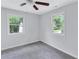 Bedroom with neutral walls, carpet, two windows for natural light, and ceiling fan at 2084 Bethel Nw Dr, Atlanta, GA 30314