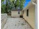 View of the exterior of the home with a gravel area and retaining wall at 2084 Bethel Nw Dr, Atlanta, GA 30314
