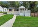 Charming home features a welcoming front porch and a well-manicured lawn at 2084 Bethel Nw Dr, Atlanta, GA 30314