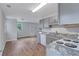 The updated kitchen includes gray cabinets, granite countertops, and modern appliances at 2084 Bethel Nw Dr, Atlanta, GA 30314