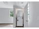 Convenient laundry area with stacked washer and dryer, wood flooring, and a window at 2084 Bethel Nw Dr, Atlanta, GA 30314