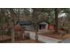 View of a gray single-story home with a tree-lined front yard and a brick mailbox at 3479 Thompson Nw Dr, Atlanta, GA 30331