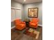 Cozy living room featuring hardwood floors, gray walls, and two orange armchairs at 3479 Thompson Nw Dr, Atlanta, GA 30331