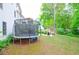 This yard features a trampoline and fire pit to provide endless outdoor activities at 533 Beecham Dr, Smyrna, GA 30082