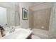 Well-lit bathroom featuring a white vanity, tiled walls, and a shower-tub combination with a stylish curtain at 533 Beecham Dr, Smyrna, GA 30082