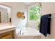 The bathroom features a corner tub, vanity with mirror, and natural light at 533 Beecham Dr, Smyrna, GA 30082