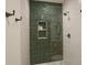 Clean shower with green tile wall featuring alcove, brushed-nickel shower head and glass surround at 533 Beecham Dr, Smyrna, GA 30082