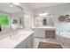 This bathroom offers marble floors, corner tub and vanity area with mirrors at 533 Beecham Dr, Smyrna, GA 30082
