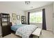 This bedroom offers a large window, dresser and neutral decor at 533 Beecham Dr, Smyrna, GA 30082