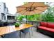Inviting outdoor deck with comfortable seating, a grill, and a large umbrella for shade, perfect for entertaining at 533 Beecham Dr, Smyrna, GA 30082
