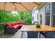 Cozy deck featuring outdoor seating under a large umbrella, offering a relaxing space surrounded by lush greenery at 533 Beecham Dr, Smyrna, GA 30082