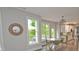 Bright dining area with modern lighting and an open view of the outdoor deck with chairs and an umbrella at 533 Beecham Dr, Smyrna, GA 30082