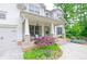 Inviting front porch with brick accents, stylish seating, and lush landscaping at 533 Beecham Dr, Smyrna, GA 30082