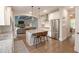 Spacious kitchen featuring granite countertops, a kitchen island with barstool seating, stainless steel appliances, and hardwood floors at 533 Beecham Dr, Smyrna, GA 30082