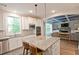 Open kitchen layout featuring granite countertops, stainless appliances, an island, and seamless flow to the living area at 533 Beecham Dr, Smyrna, GA 30082