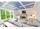 Cozy living room featuring a stone fireplace, coffered ceiling and a large sectional sofa at 533 Beecham Dr, Smyrna, GA 30082