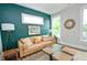 Stylish living room with a dark green accent wall, light-colored couch, and modern decor for a comfortable atmosphere at 533 Beecham Dr, Smyrna, GA 30082
